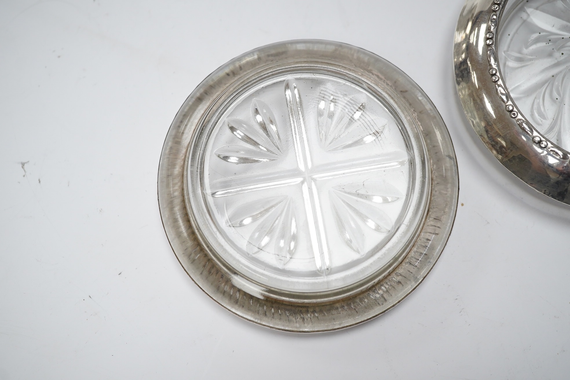 A set of four silver rimmed cut glass coasters, diameter 93mm. Condition - poor